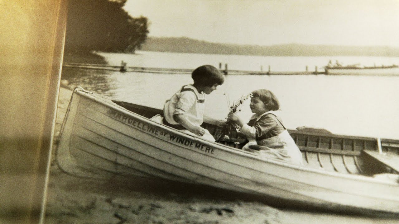 Sepia photo of two kids in a canoe